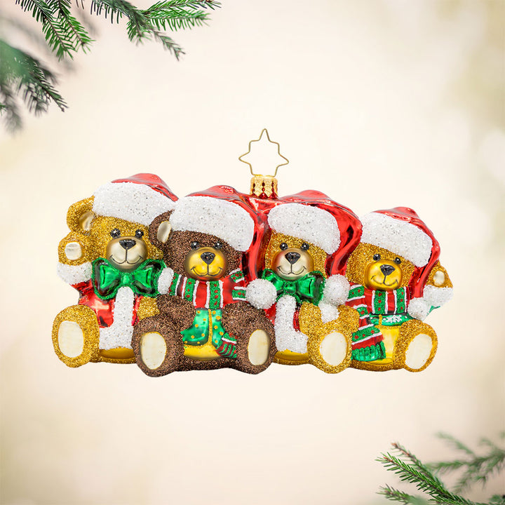 Teddy Train Treasures ornament. A charming lineup of teddy bears, each dressed in a Santa hat with their rosy cheeks, and tiny paws. View of front.
