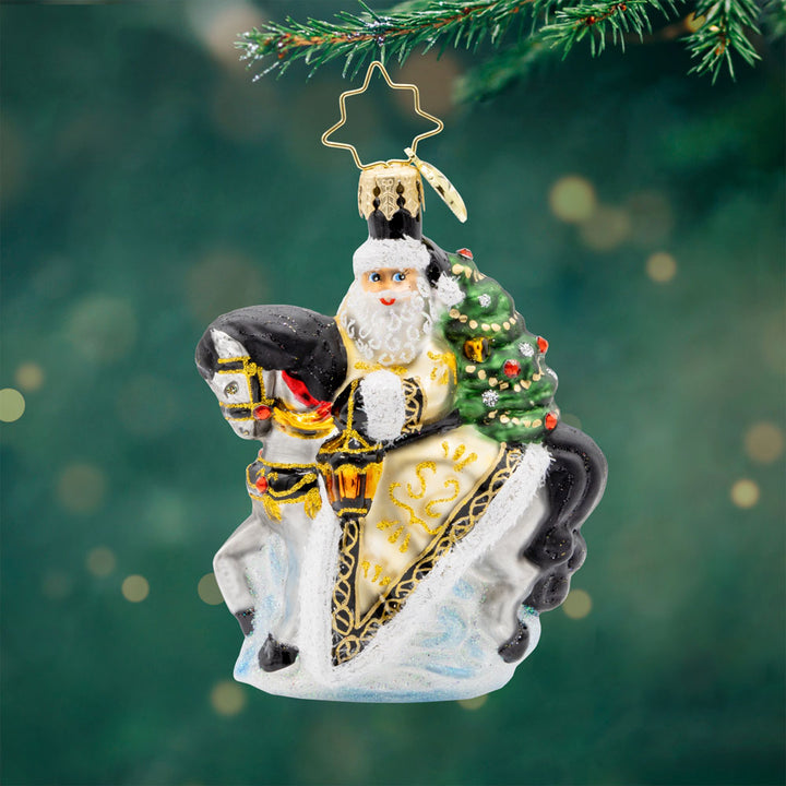 Golden Coat Calvary Gem ornament. Santa rides a white horse with a black mane, decorated in gold with a Christmas tree on his back. View of front. 