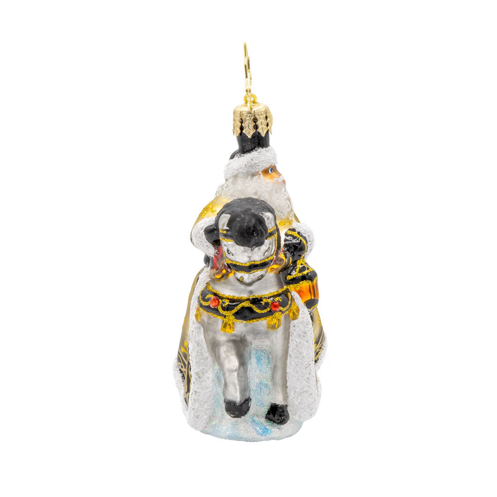 Golden Coat Calvary Gem ornament. Santa rides a white horse with a black mane, decorated in gold with a Christmas tree on his back. View of left side.