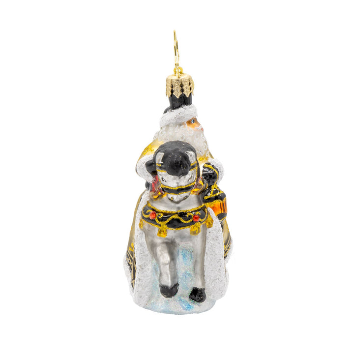 Golden Coat Calvary Gem ornament. Santa rides a white horse with a black mane, decorated in gold with a Christmas tree on his back. View of left side.