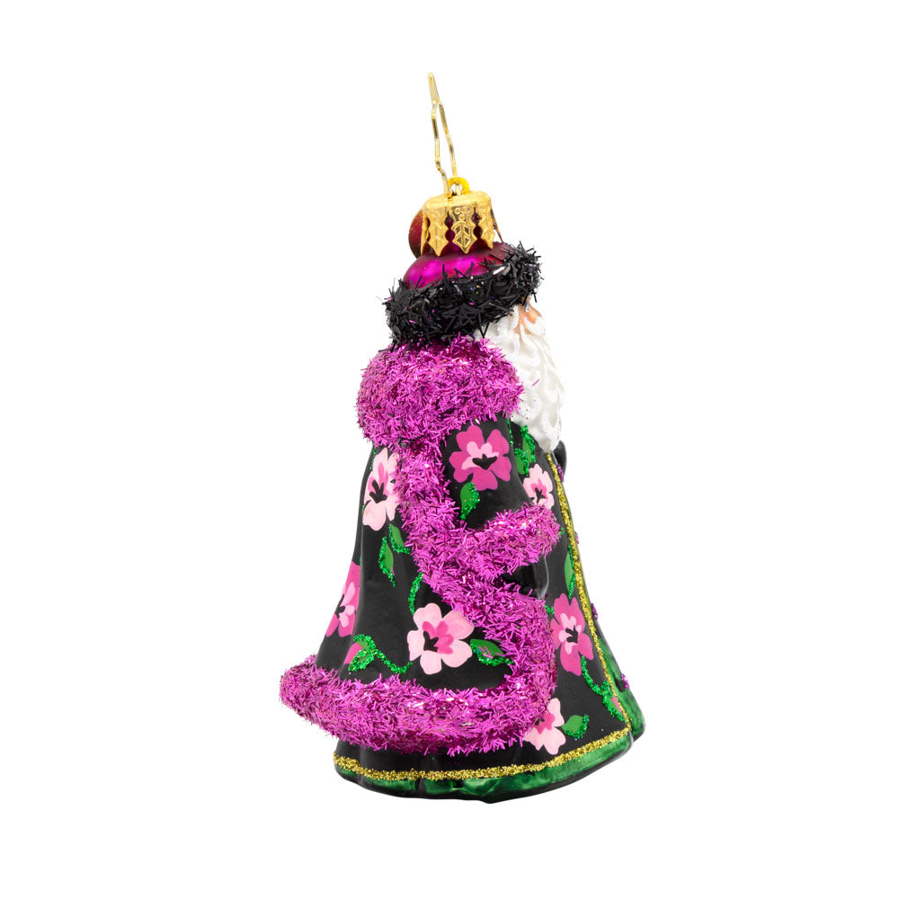 Midnight Blossom St. Nick Gem ornament. Santa dons a black and pink robe with hand-painted floral designs. He holds a gold scepter. View of left side.