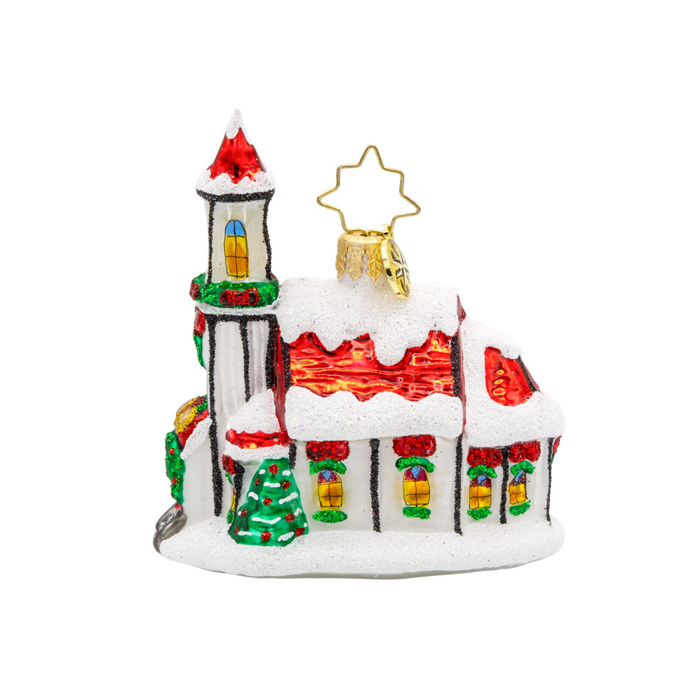 Holly Bell Chapel Gem ornament. A snow-covered chapel with a red roof adorned with wreathes galore. View of right side.