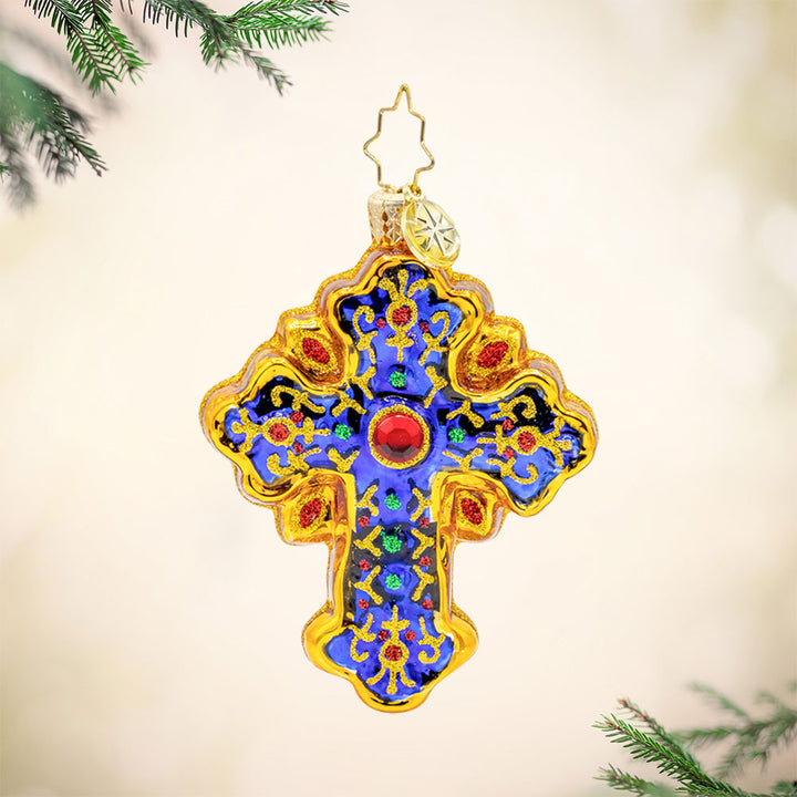 Sacred Season Cross Gem ornament. A gold and blue cross adorned with red and green jewels. View of front. 