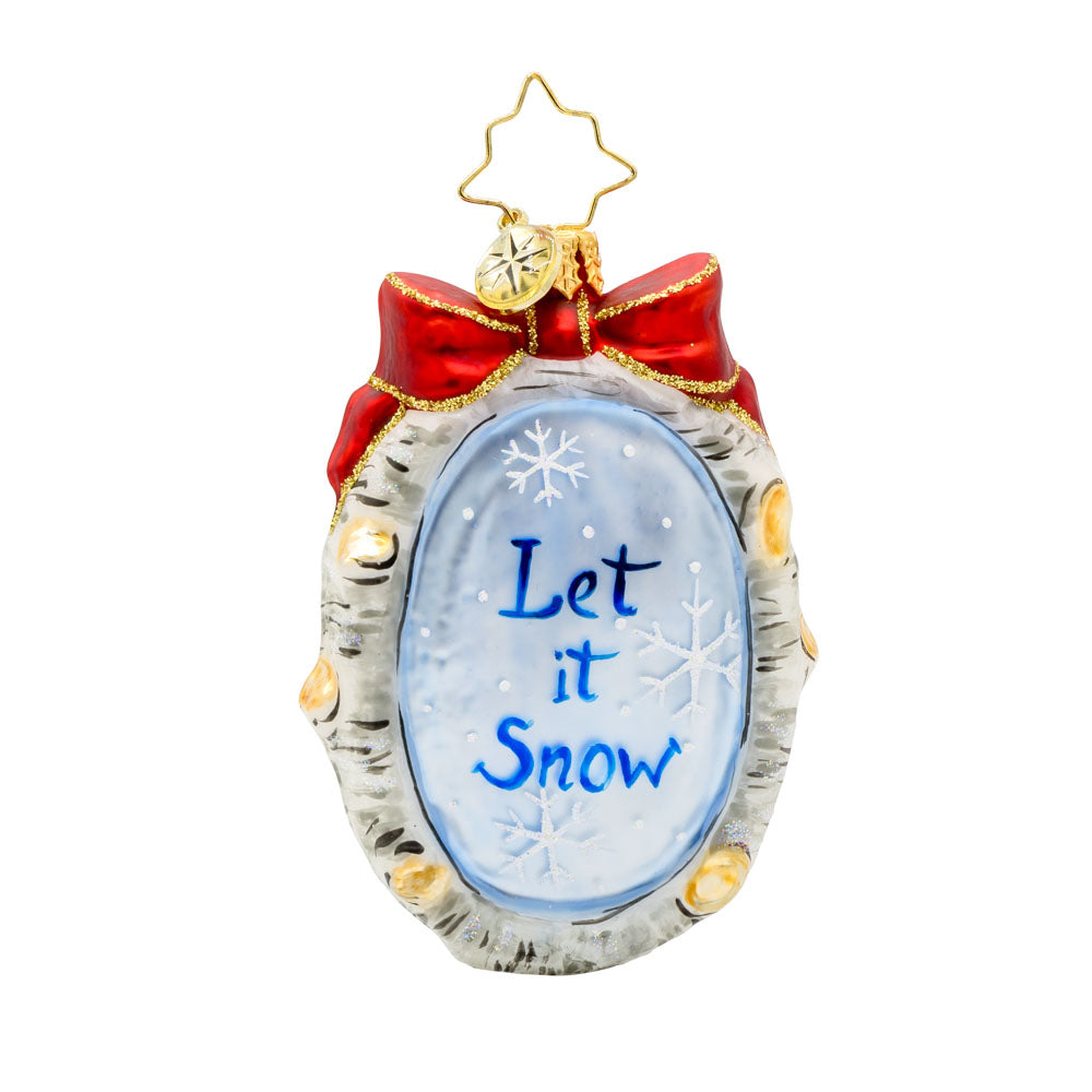 A Snowy Feathered Friend Gem ornament. A snowman and a cardinal in its birdhouse, are encircled by a wreath made of birch branches with a red bow on top. View of back.