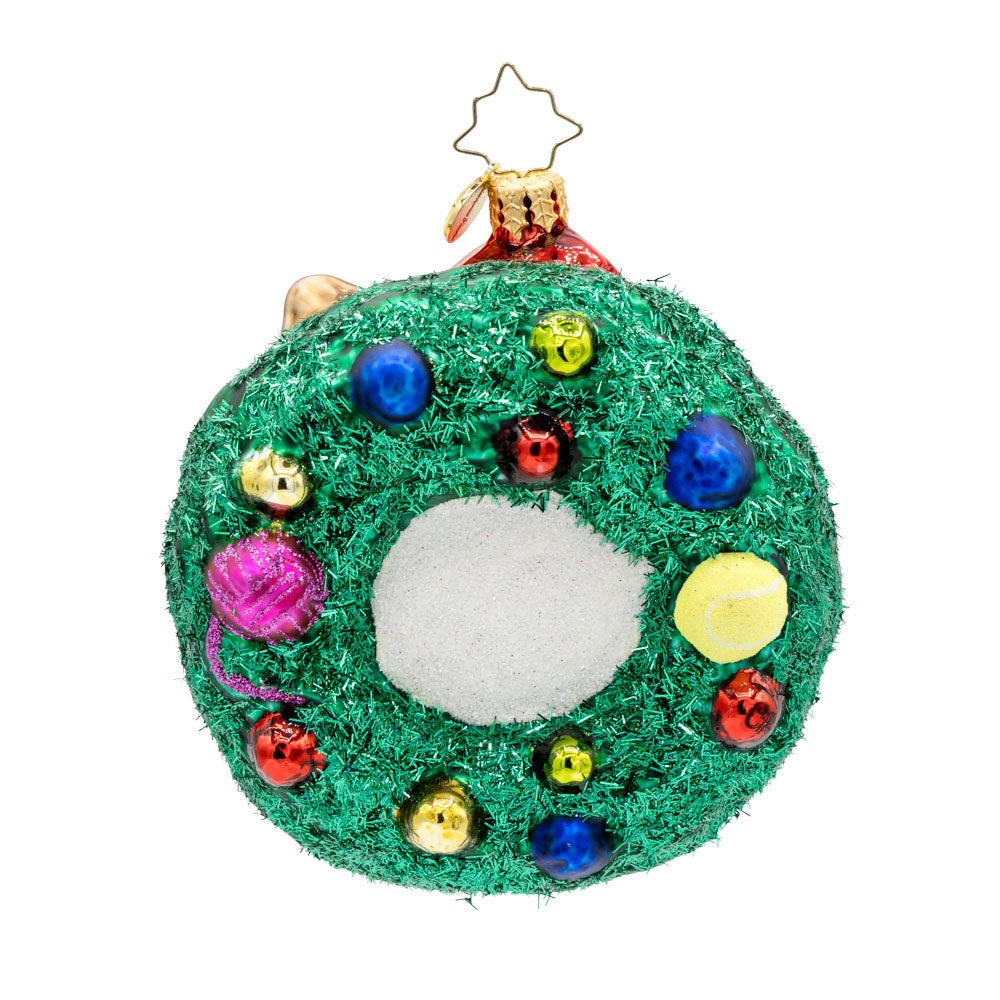 Merry Catmas ornament. Features a cat wearing a Santa hat, encircled by a wreath and toys. View of back.