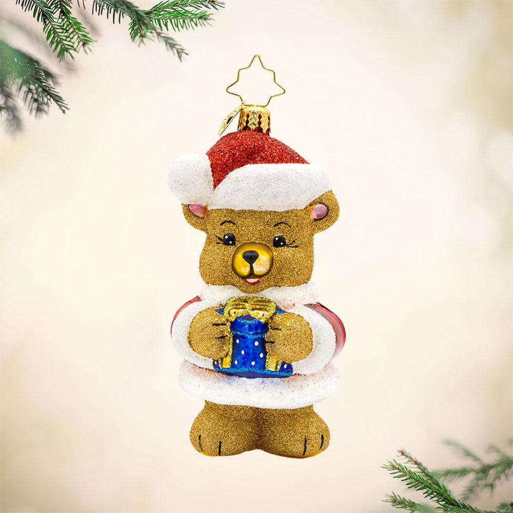 Bear-y Special Present ornament. A teddy bear dressed in a Santa outfit holds a gift. View of front. 