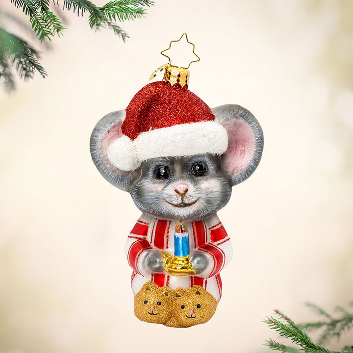 Snug-as-a-Bug ornament. A mouse in striped pajamas, complete with a fluffy Santa hat perched on its tiny head and candlelight in hand. View of front. 