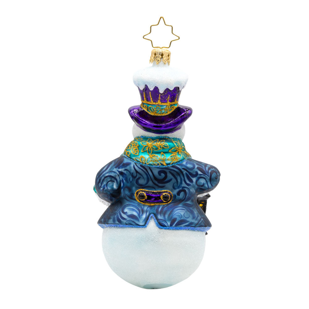 Winter Wanderer ornament. This charming snowman is adorned in a luxurious purple scarf and hat, he is carrying a lantern. View of back.