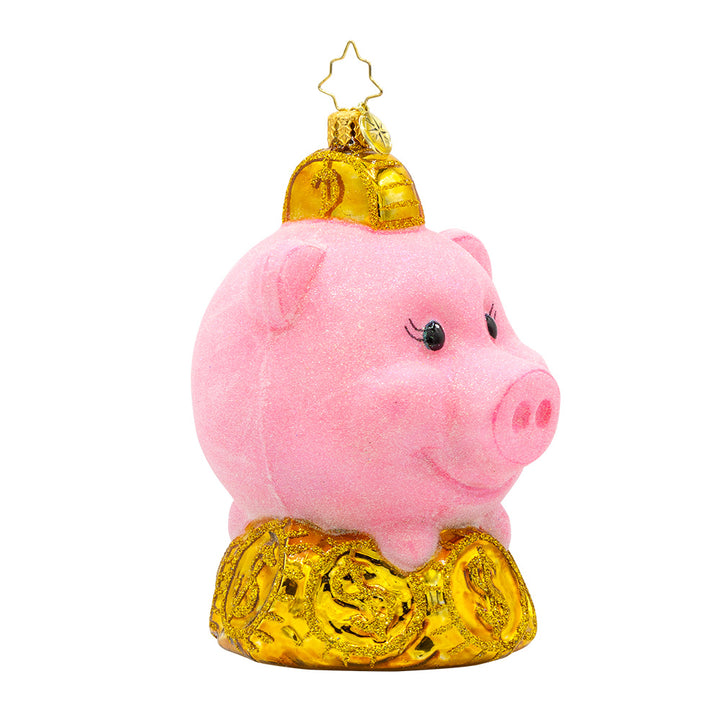 Piggy Pal ornament. Features a fuzzy bright pink piggy bank and sparkling gold coins. View of front at left angle.