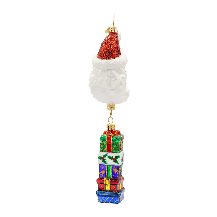 Lunar Treasures ornament. Santa's head in the shape of a crescent moon, with a stack of gifts dangling below. View of left side.