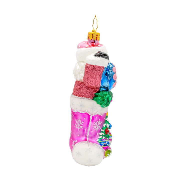 Santa's Stocking Stuffer ornament. Santa wears a shimmering pink suit and glittery hat. A colorful assortment of shiny brite ornaments adorn the stocking. View of left side.