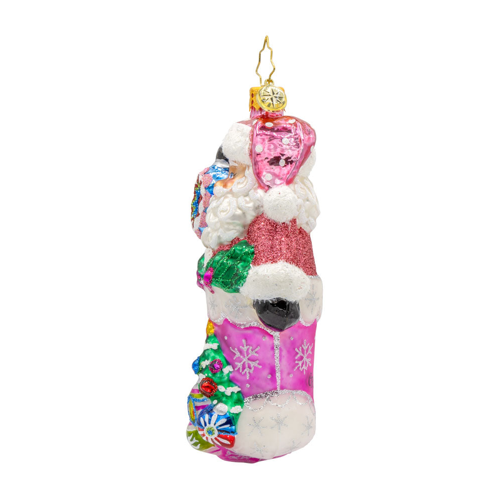 Santa's Stocking Stuffer ornament. Santa wears a shimmering pink suit and glittery hat. A colorful assortment of shiny brite ornaments adorn the stocking. View of right side.