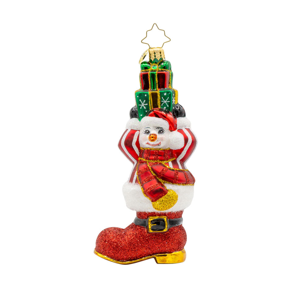 Snowman Surprise ornament. This snowman is wearing a striped sweater, popping out of a red boot, with a stack of gifts in hand. View of front. 