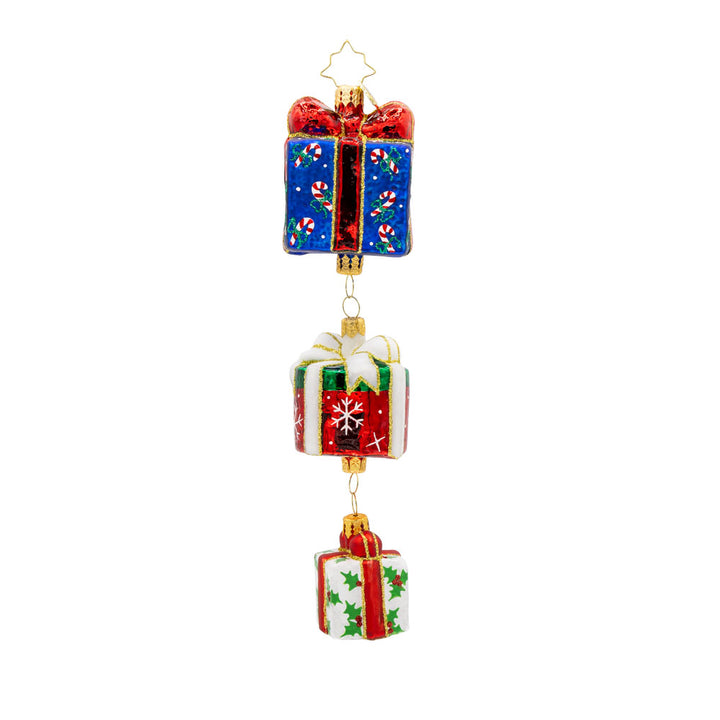 Holiday Haul ornament. This charming piece features three beautifully wrapped presents, each with a unique design and color. View of front.