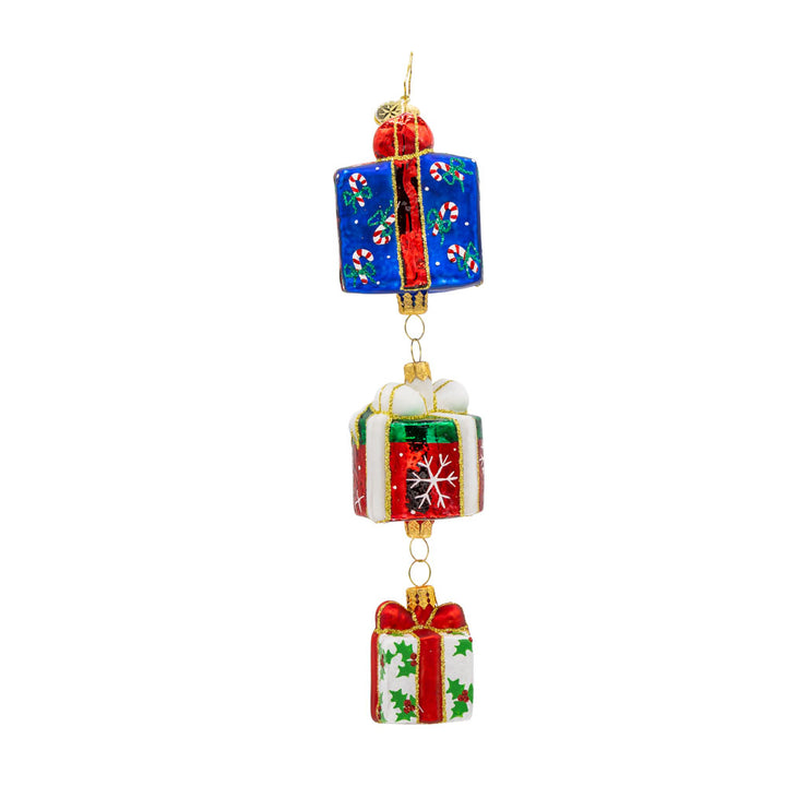 Holiday Haul ornament. This charming piece features three beautifully wrapped presents, each with a unique design and color. View of  back.