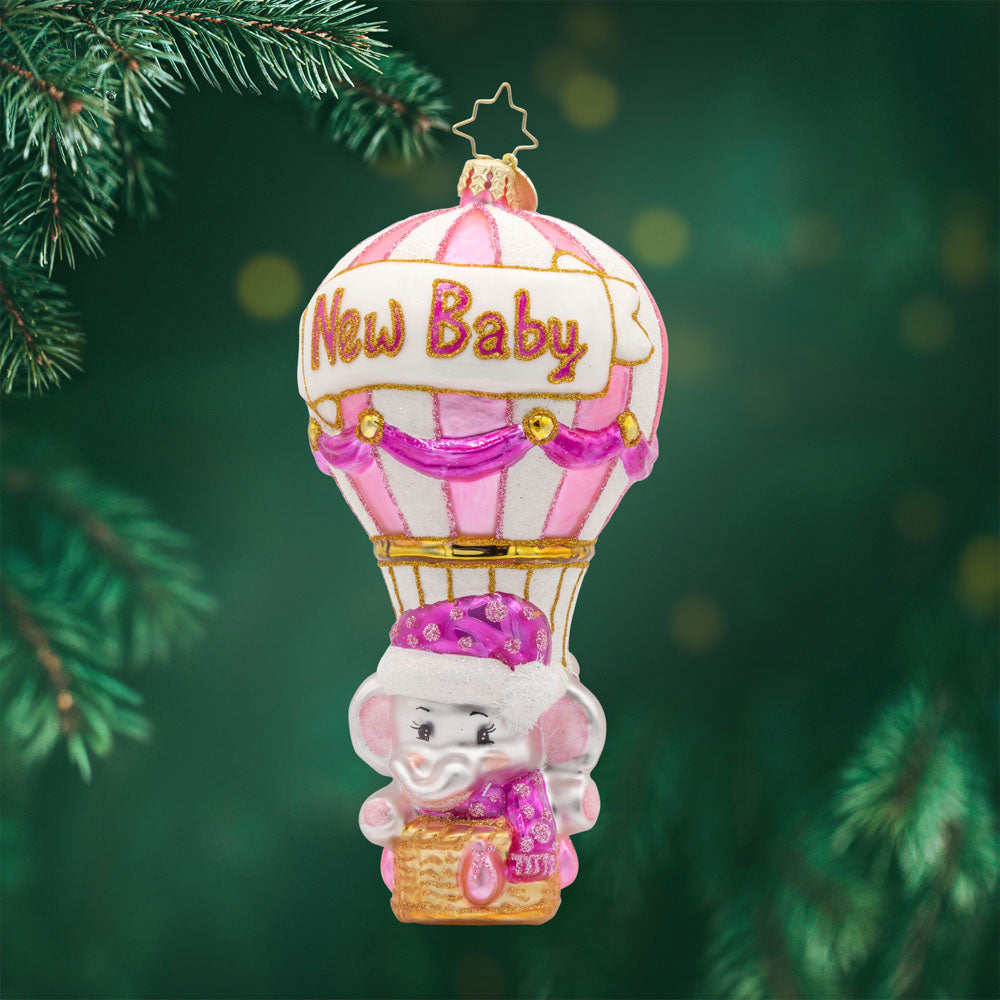 Baby Pink Balloon Adventure ornament. Features a baby pink elephant in a hot air balloon that has "New Baby" written on it. View of front. 
