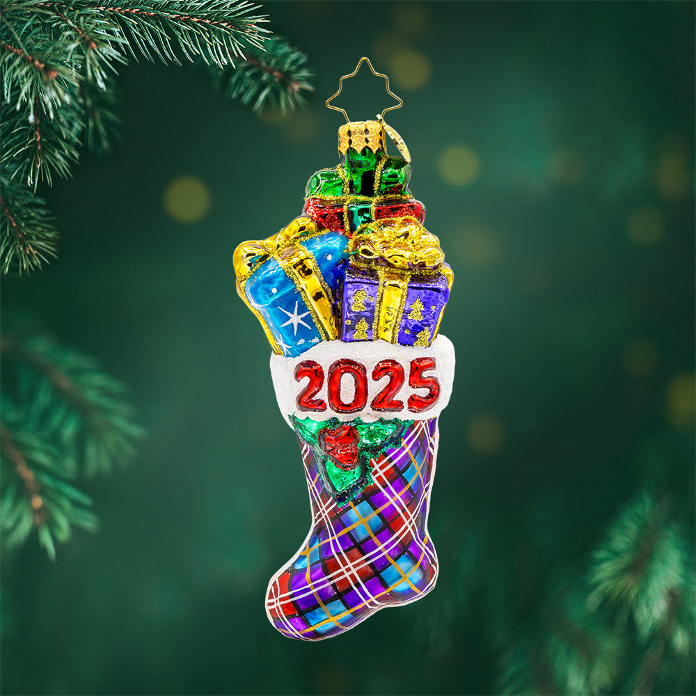 2025 Stacked Holiday Joy ornament.  Hand-painted plaid stocking dated "2025" with presents coming out the top. View of front. 