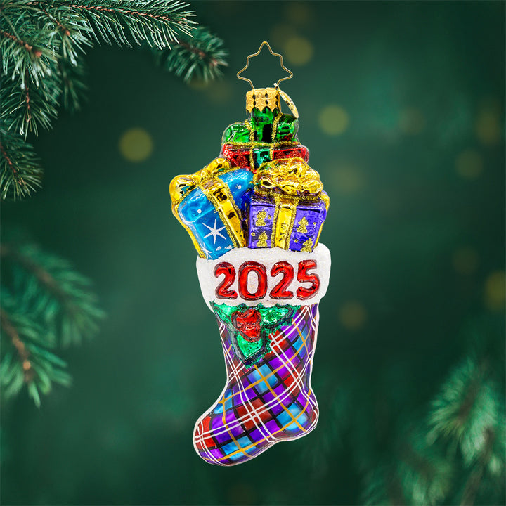 2025 Stacked Holiday Joy ornament.  Hand-painted plaid stocking dated "2025" with presents coming out the top. View of front. 