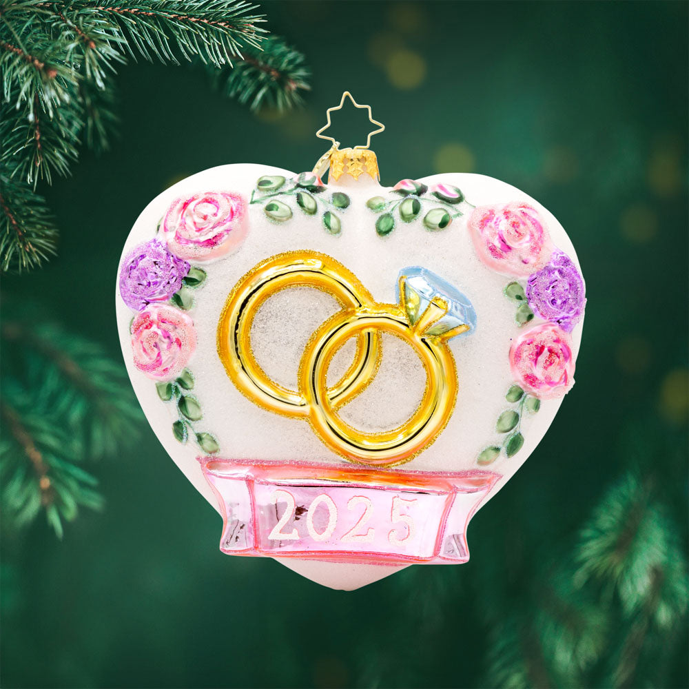 Everlasting Love ornament. Adorned with delicate satin florals and sparkling rings. Dated "2025." View of front.