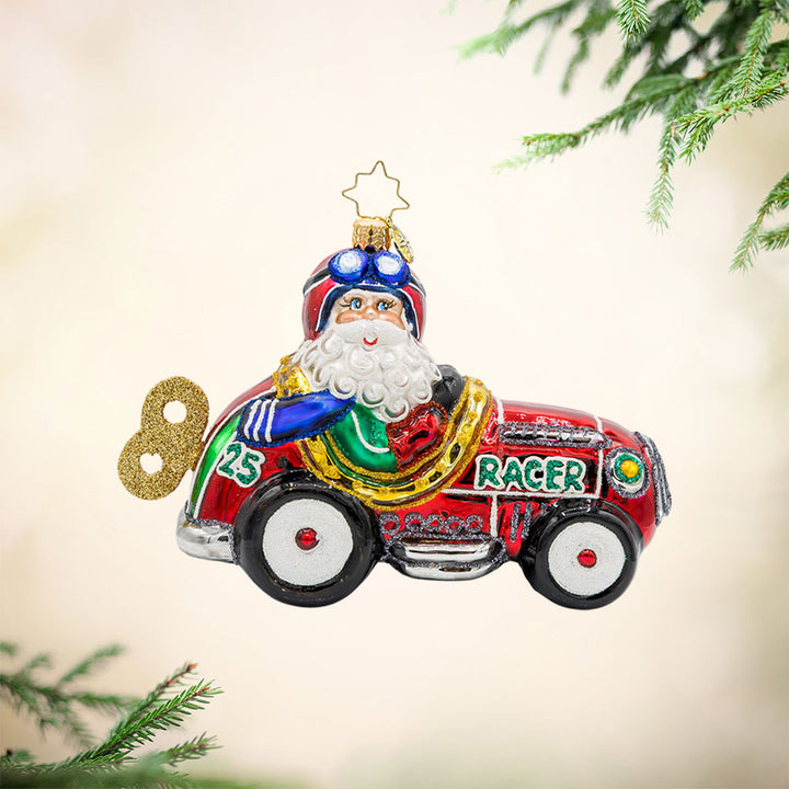 Kris Kringle Kart ornament. Santa speeds in a red racer car. View of front. 