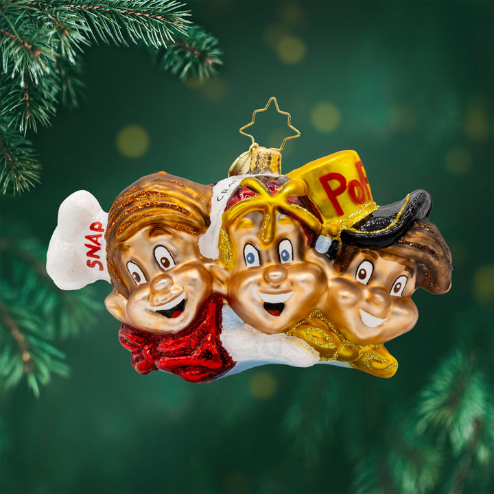 The Breakfast Buddies ornament. Showcasing the Rice Krispies mascots in their classic attire: Snap with his red cap, Crackle with his yellow hat, and Pop with his blue hat. View of front. 