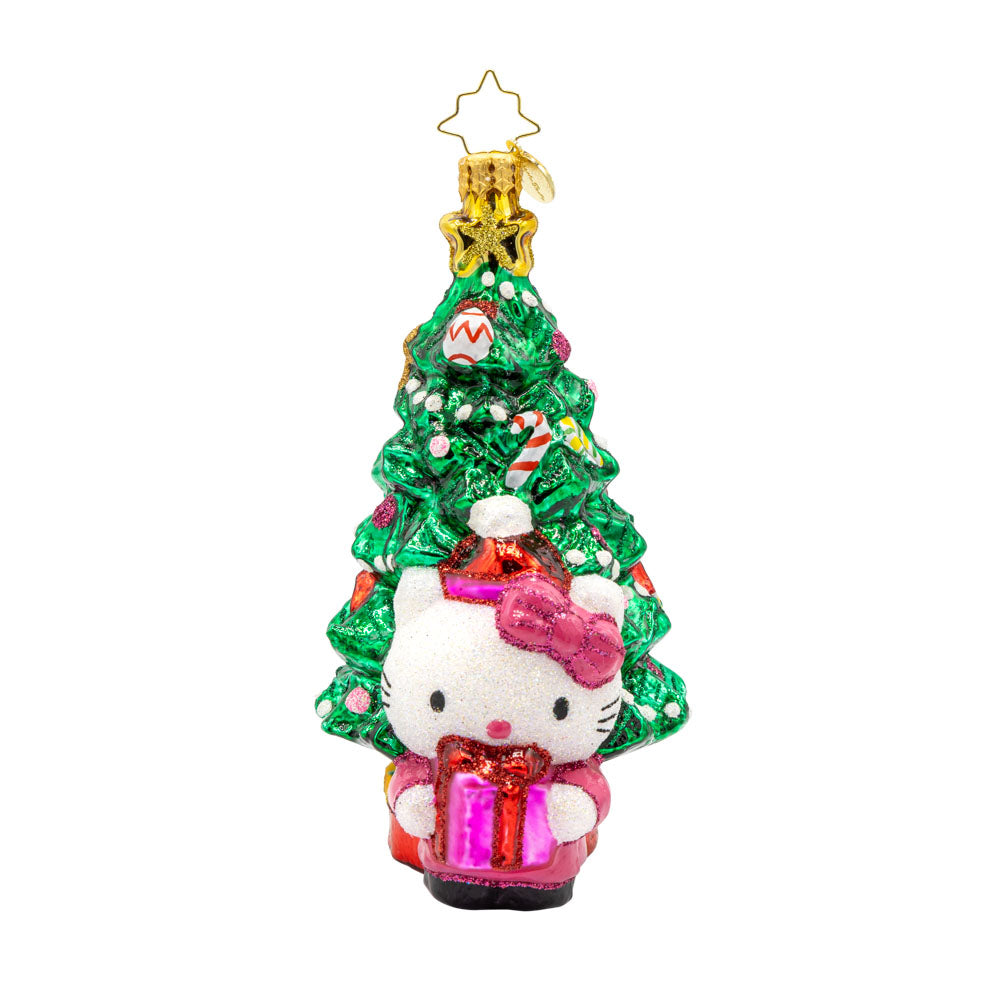 Hello Kitty's Christmas Cheer ornament. Hello Kitty is bundled up in red and pink in front of a decorated Christmas Tree. View of front.