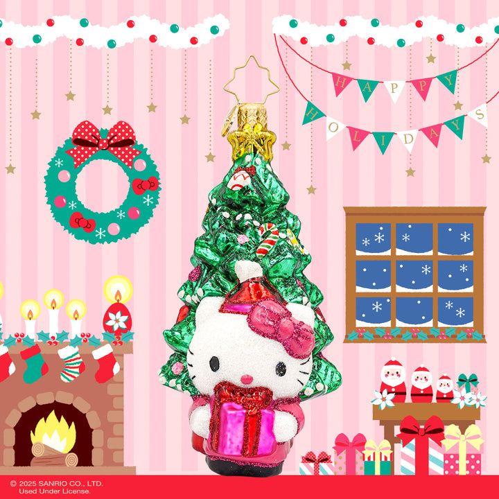 Hello Kitty's Christmas Cheer ornament. Hello Kitty is bundled up in red and pink in front of a decorated Christmas Tree. View of front.