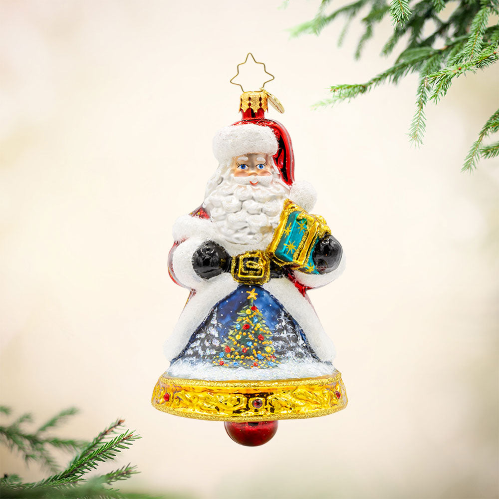 Jingle All The Claus ornament. The bottom of Santa's body creates a bell. The hand-painted scene on his coat features a snowy village and a twinkling Christmas tree. View of front. 