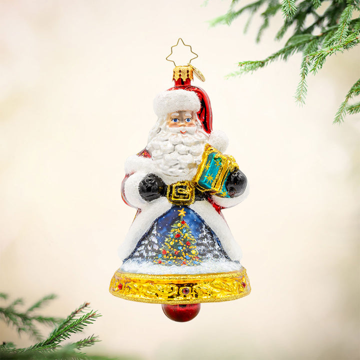 Jingle All The Claus ornament. The bottom of Santa's body creates a bell. The hand-painted scene on his coat features a snowy village and a twinkling Christmas tree. View of front. 