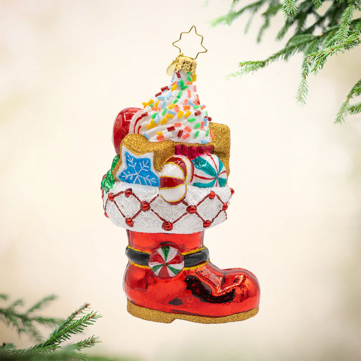 Candy Cane Kick ornament. Features Santa’s classic red boot, brimming with sweet treats. View of front. 