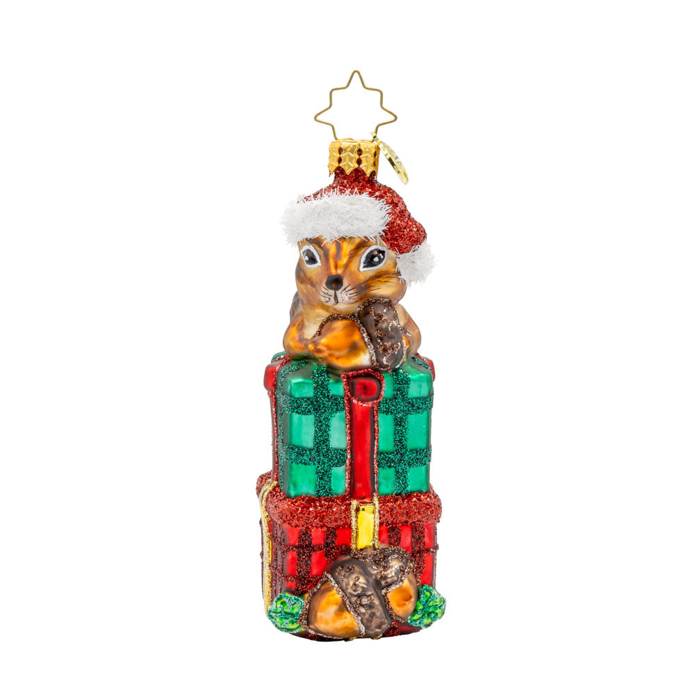 Chipper Cheer ornament. A chipmunk sits atop a stack of gifts with an acorn in hand. View of front.