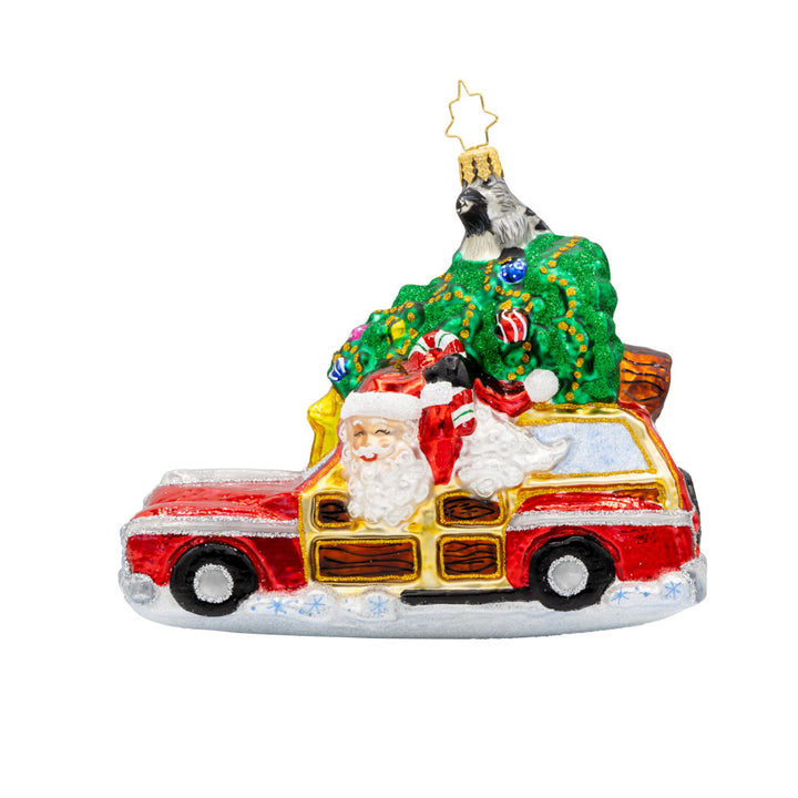 Santa's Woodland Adventure ornament. A raccoon catches a ride on the Christmas tree above Santa's car. View of front.