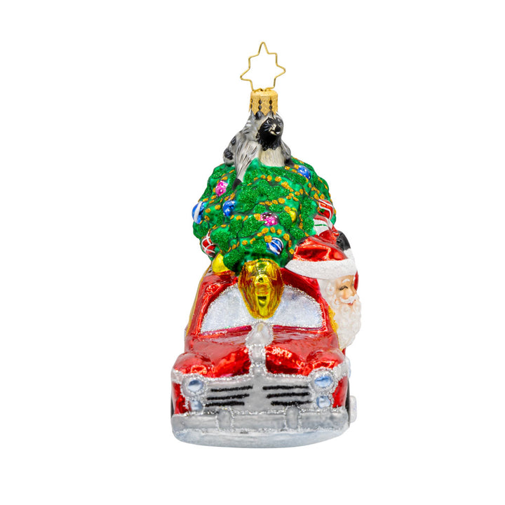 Santa's Woodland Adventure ornament. A raccoon catches a ride on the Christmas tree above Santa's car. View of left side.