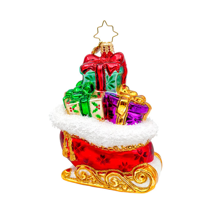 Sleighful of Wonders ornament. A bright red and gold sleigh is overflowing with gifts. View of front. 