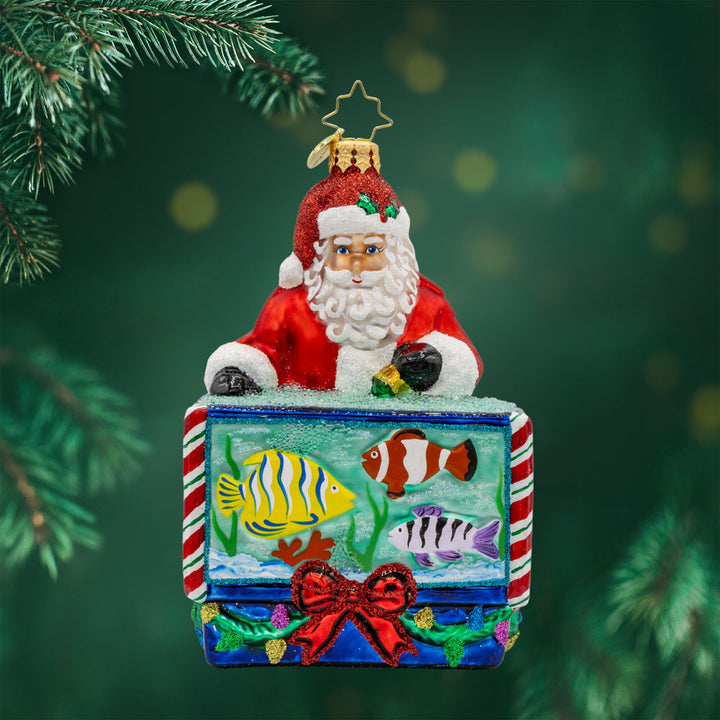 St. Nick's Nautical Nook ornament. Featuring Santa with a magical aquarium filled with colorful fish. View of front. 