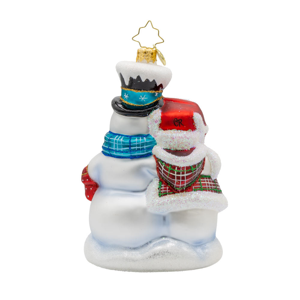 Winter Lovebirds ornament. A lady and gentleman snowman cuddle up with a cup of hot cocoa. View of back.
