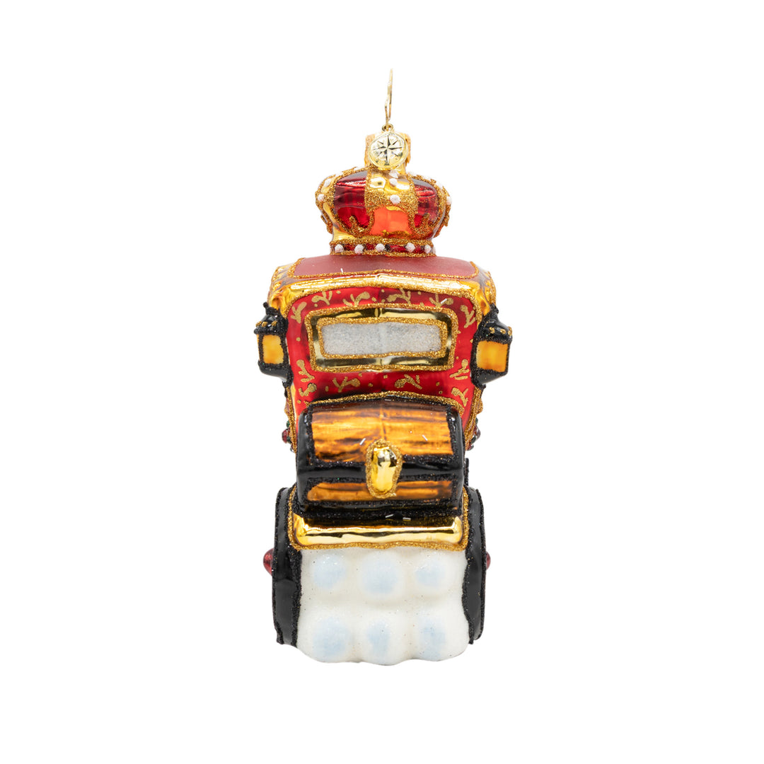 Back view ornament of Santa riding in a red and gold detailed carriage while being pulled by a brown reindeer. showcases back details of the treasure chest sitting on the back of the carriage.