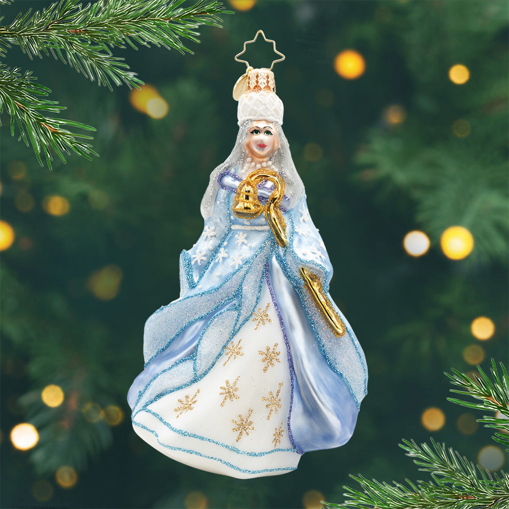 Echoes of Christmas Past. Ornament of the ghost of Christmas past in a sparkly light blue and white dress while holding a golden staff. View of front.