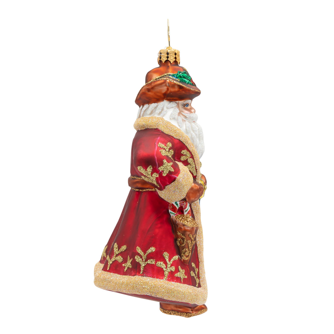 Decorative Santa figure with a red coat, gold accents and a brown cowboy hat on a white background