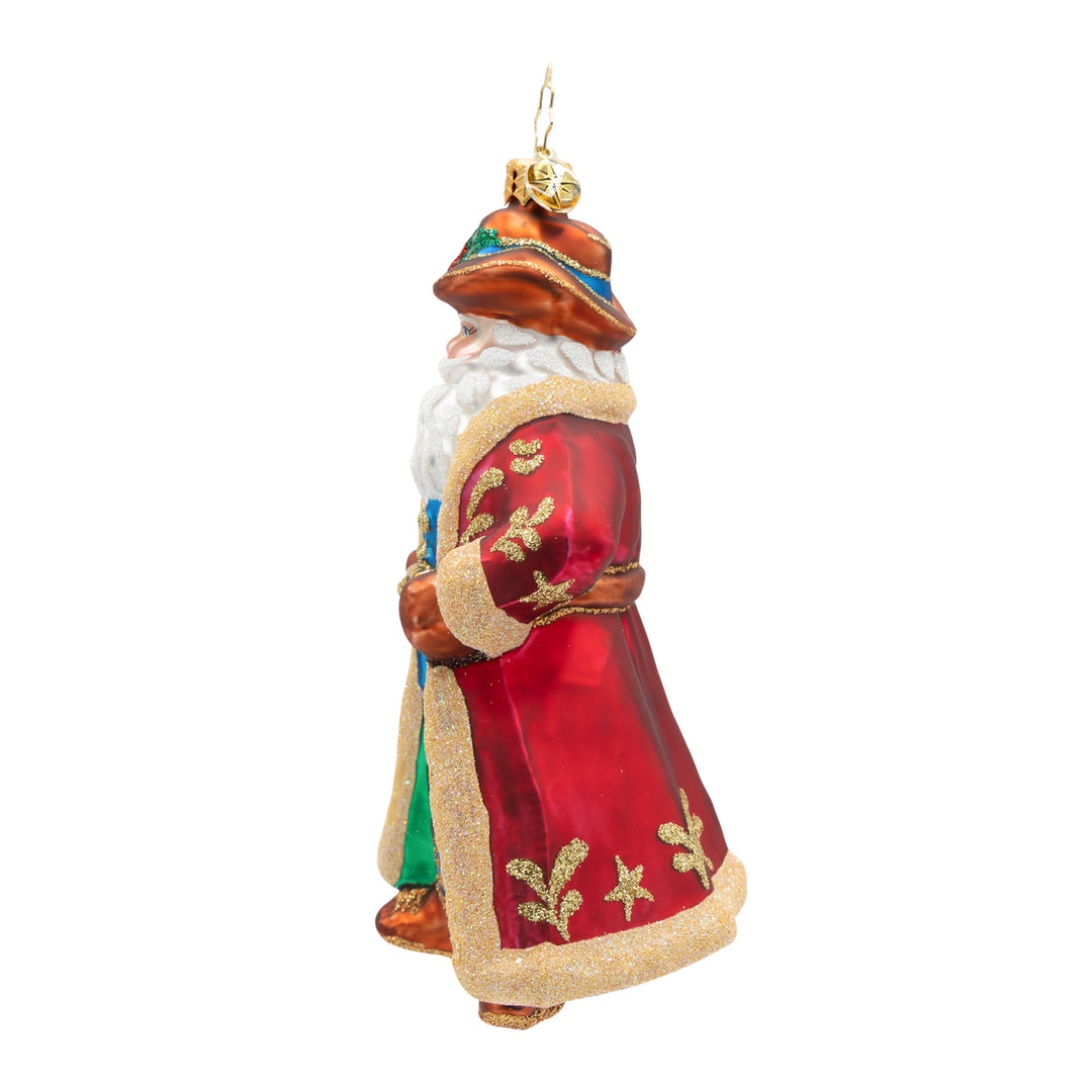 Decorative Santa figure with a red coat, gold accents and a brown cowboy hat on a white background