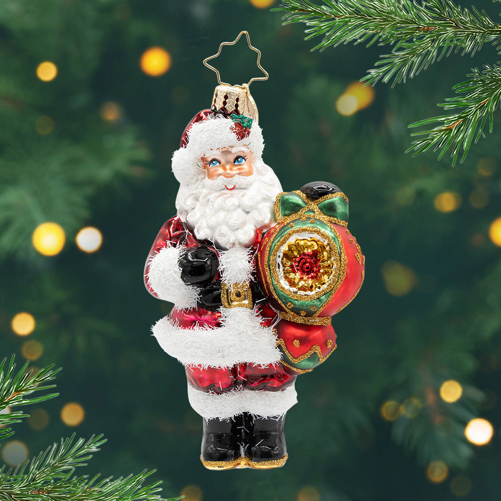 The Merry Bauble Santa. A classic Santa ornament holding a red and gold ornament. View of front