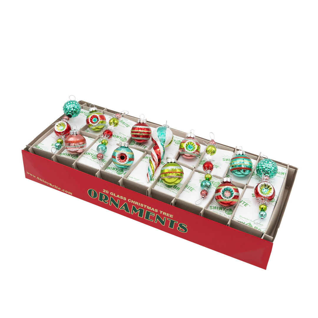 FESTIVE FETE 13 COUNT 4” ICICLES & 1.25” ROUNDS. Eight round ornaments with different colored stripes. Four icicle ornaments made with five to seven ornaments and some ranging in different sizes, and ornament shaped like an icicle, with all the ornaments ranging in colors of red, green, teal, and pink.