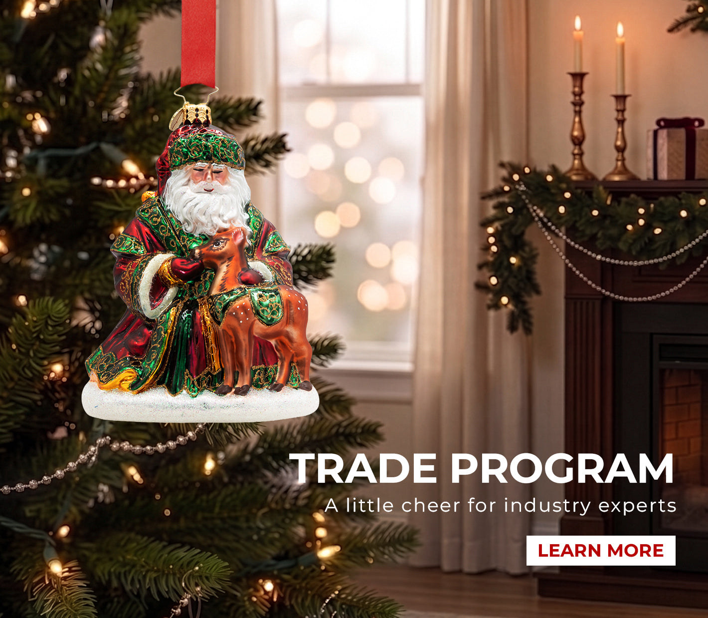 A detailed Santa Claus Christmas ornament in a rich red and green robe, holding a baby reindeer, hanging on a decorated tree in a cozy holiday living room.