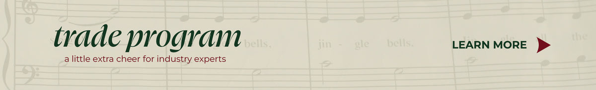 Promotional banner reading "trade program - a little extra cheer for industry experts" with a "LEARN MORE" button over a vintage sheet music background featuring the song "Jingle Bells".