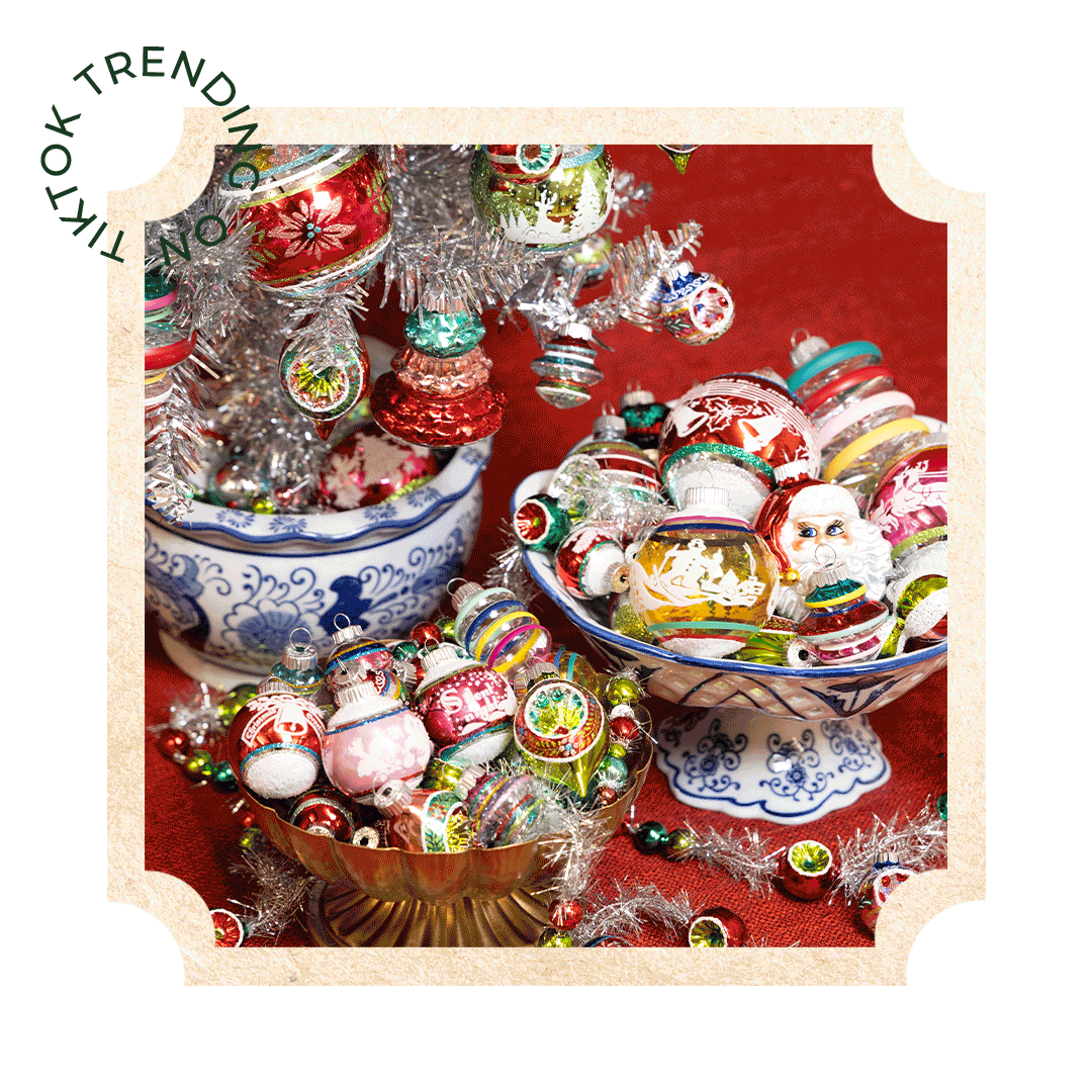 Vintage Shiny Brite Christmas ornaments displayed in decorative bowls next to a small silver tree with a "Trending on TikTok" badge.