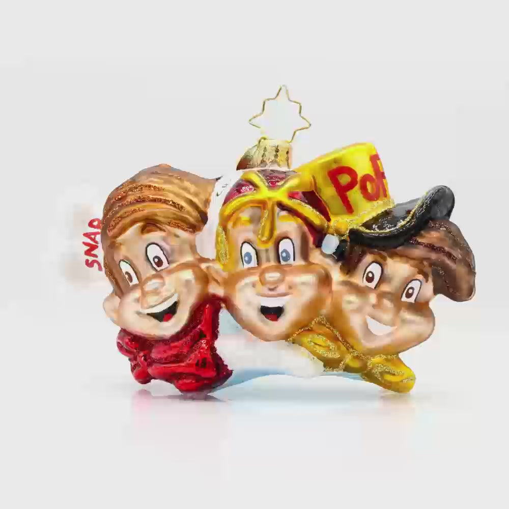 The Breakfast Buddies ornament. Showcasing the Rice Krispies mascots in their classic attire: Snap with his red cap, Crackle with his yellow hat, and Pop with his blue hat. Video.