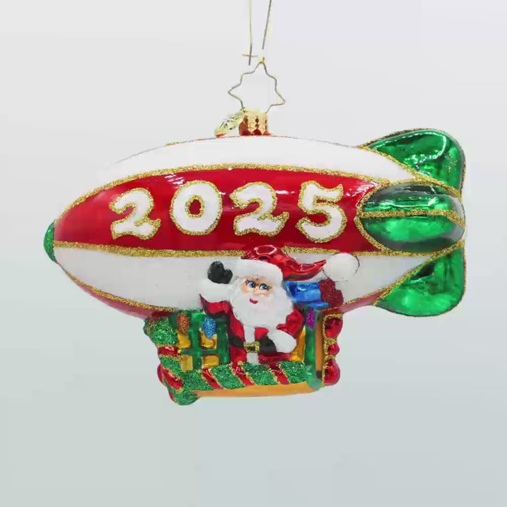Flying Over the Years ornament. This ornament features Santa piloting a blimp, dated "2025." Video.