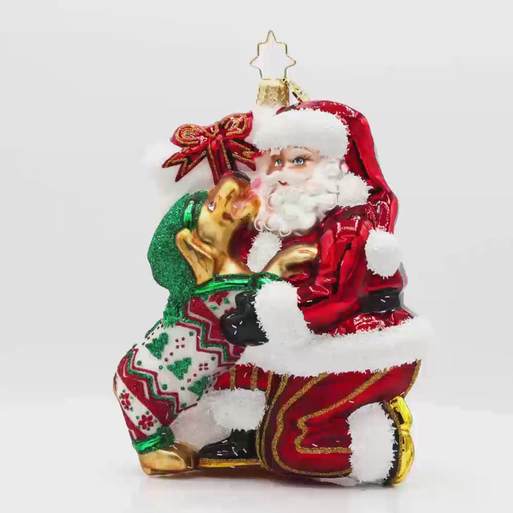 Santa's Pawsome Playtime ornament.  Santa has a playful pup dressed in festive pjs to keep him company. Video.