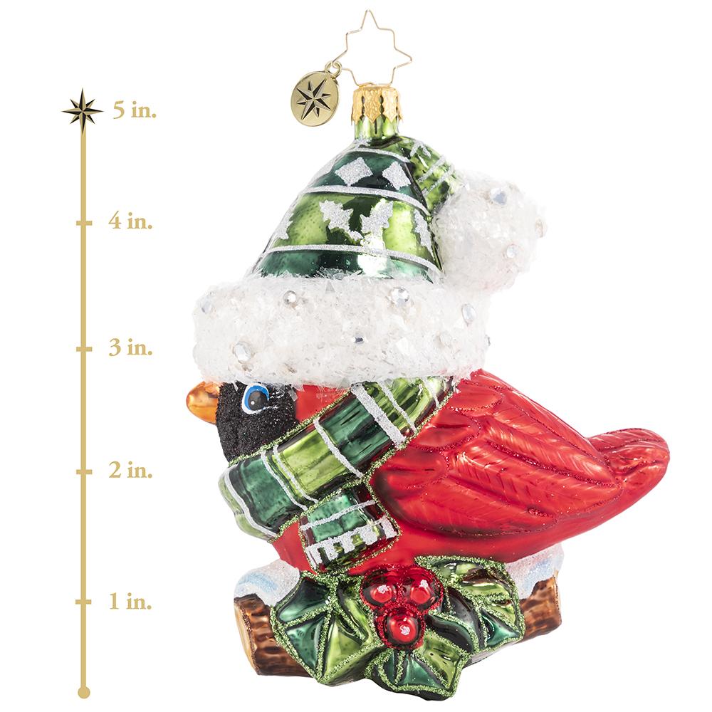 Ornament Description - Bundled-Up Feathered Friend: When temperatures drop, every forest creature must find their own way to keep warm. This creative cardinal was lucky to come across this pint-sized set to bundle up--perched high on a holly branch, he shows off his festive finds for all to see. This photo shows the ornament is about 5 inches tall.