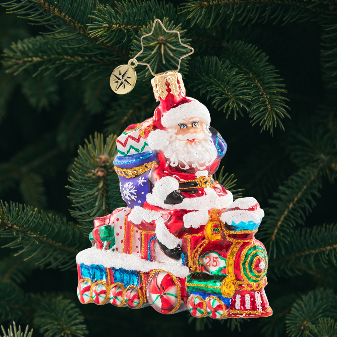 Ornament Description - On the Tracks Santa Gem: Choo chooâ€”it is the Holiday Express! Santa is all aboard on this little locomotive, on his way to spread Christmas cheer to one and all.